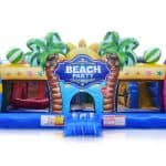Inflatable bounce house with "Beach Party" sign, palm tree decorations, colorful beach balls, and surfboards—perfect for bounce house Long Island events and party rentals Long Island—set against a white background.