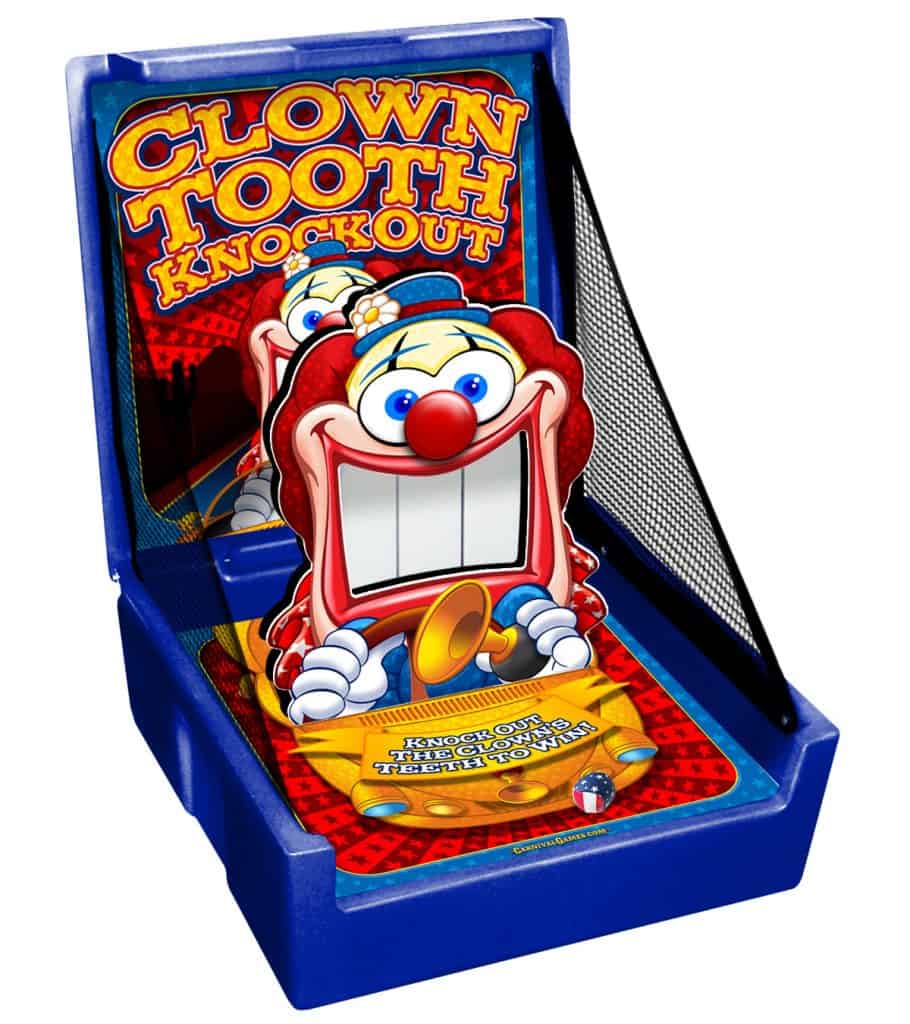 A colorful arcade game called "Clown Tooth Knockout" features a cartoon clown face with large white teeth—perfect for party rentals Long Island, NY. The setup boasts a netted side and playful graphics with bold yellow and red lettering.