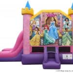 Colorful inflatable bounce house Long Island and slide featuring Disney princesses—Cinderella, Belle, Ariel, Jasmine, and more—with pink and purple castle-like towers and a “Disney Princess” sign above the entrance; perfect for NY party rentals!.