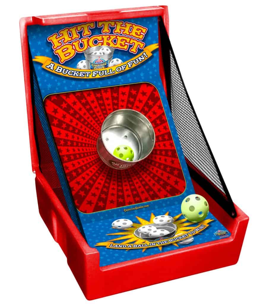 A tabletop arcade game called "Hit the Bucket" with a metal bucket target in the center, featuring two perforated plastic balls and colorful graphics on a red and blue background—perfect for party rentals Long Island, NY.