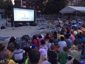 kids looking at inflatable movie screen