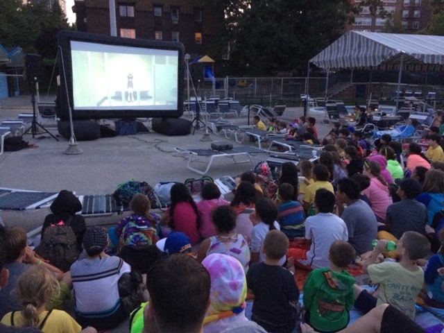 kids looking at inflatable movie screen