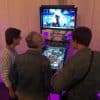 people watching a person play pinball