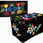 A rectangular arcade game table with colorful light-up buttons on top and the text "Play Back Memory Challenge" printed on the sides. Perfect for party rentals Long Island, two people are pressing the buttons in a top-down view inset.