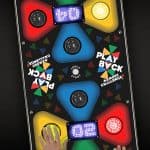 Overhead view of two players pressing colored, illuminated buttons on an electronic game board labeled "Play Back Memory Challenge!"—a fun addition to any party rentals Long Island event with vibrant lights and digital score displays.