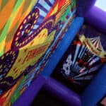 Colorful, inflatable funhouse walls with circus-themed designs and bold patterns—perfect for NY parties. This bounce house Long Island favorite features bright banners and a striped circus tent illustration.