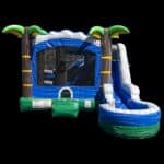 The 7 in 1 Tropical Combo is an inflatable bounce house with a slide, blue, green, and white colors, palm tree corners, and a black background—perfect for party rentals in Long Island, NY.