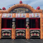 An inflatable carnival game resembling a jumbo slot machine, complete with bright lights, colorful graphics, and three “Match 3 & Win” entrances—perfect for outdoor events and party rentals Long Island, NY.