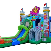 A Super Mario Brothers inflatable bounce house designed like a colorful castle with turrets, flags, a dragon, a slide, and an arched tunnel entrance. The structure features cartoon images and a bright, playful appearance.